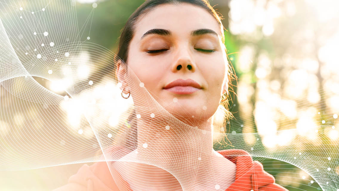 a woman breathes deeply with her eyes closed.
