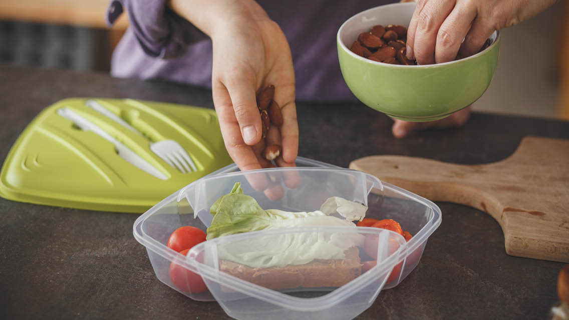 a woman packs healthy snacks