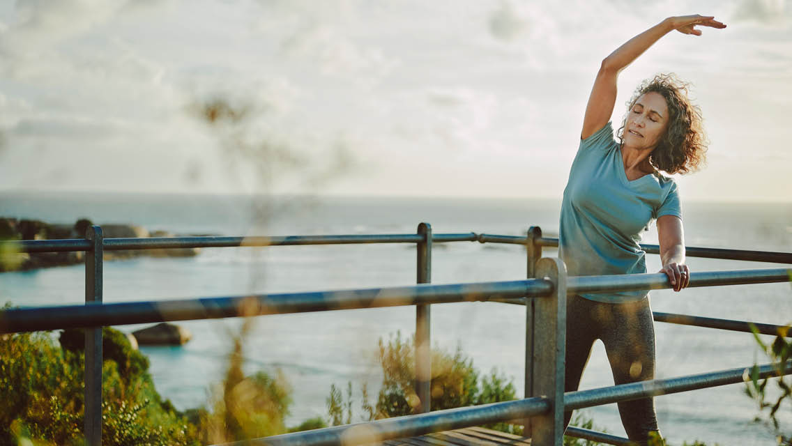 a woman stretches outside