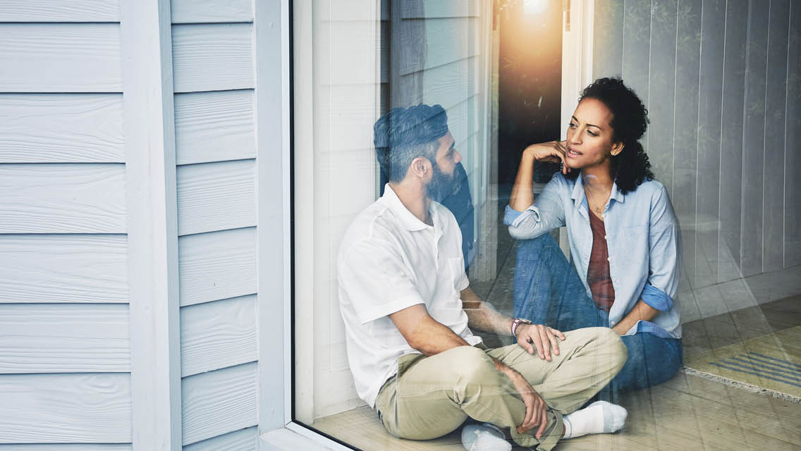 a couple sits talking to each other