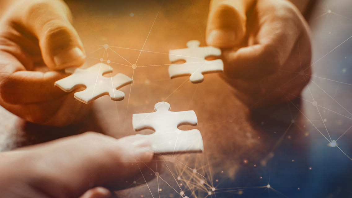 illio of hands putting puzzle pieces together