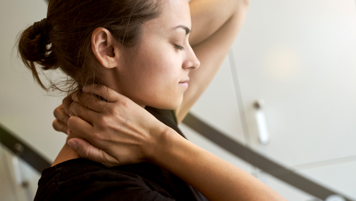 a woman pressing pressure point on neck