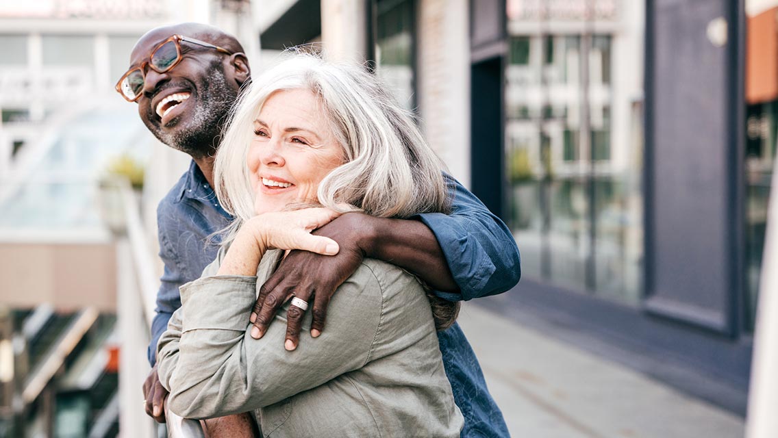 A couple looking over balcony.