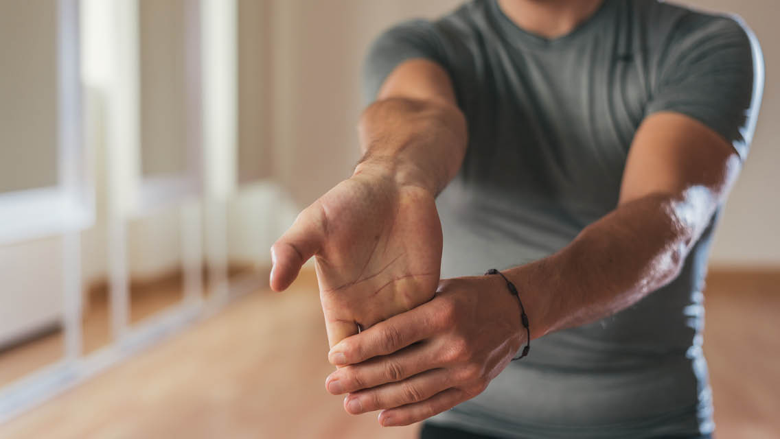 a person stretches their wrist
