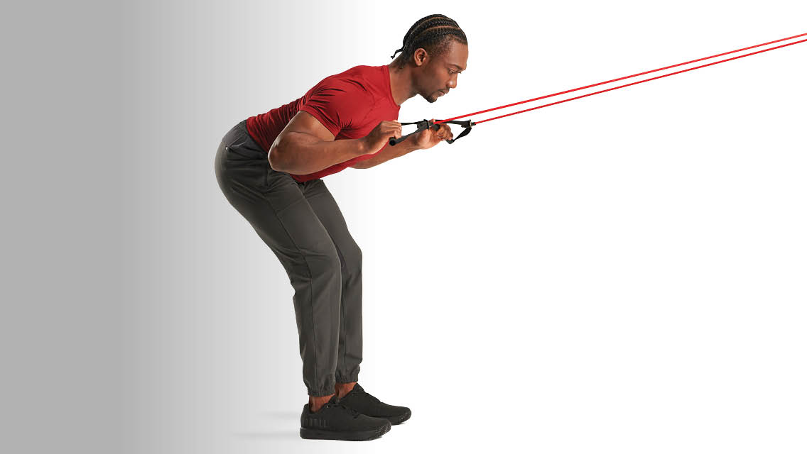 a man performs a lat pull with a band