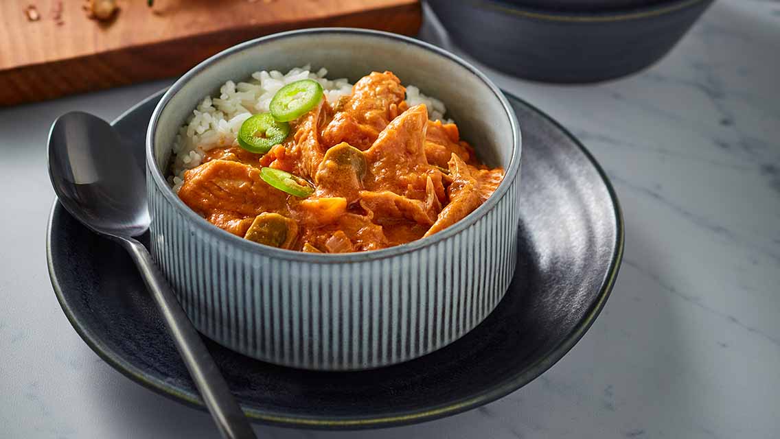 a bowl of senegalese maafe peanut stew served over rice