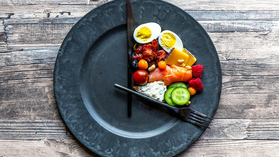 a plate of healthy food shaped into a clock with the food in a 1/3 of it