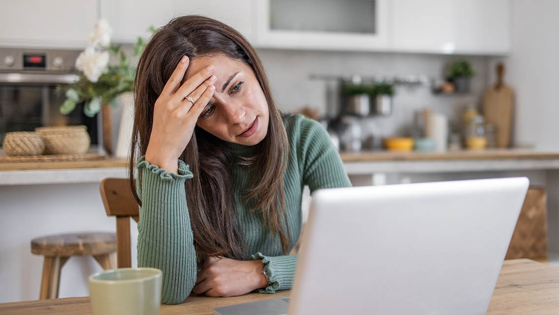 a woman looking perplexed at her computer