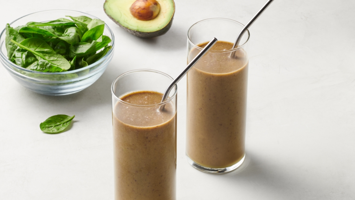 Two glasses of Coach Lo's signature green shake.