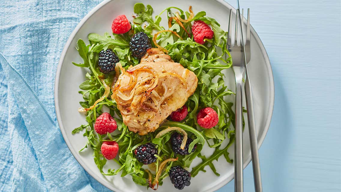 chicken with berry-balsamic baste on a bed of greens