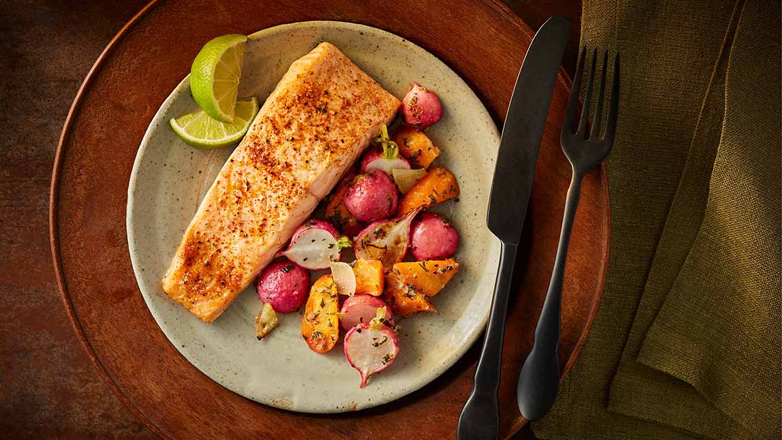 a plate of salmon and veggies