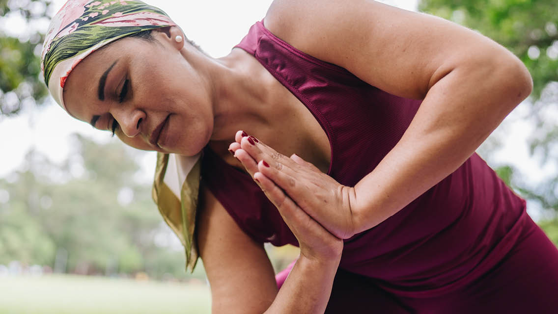 a woman holds a yoga pose