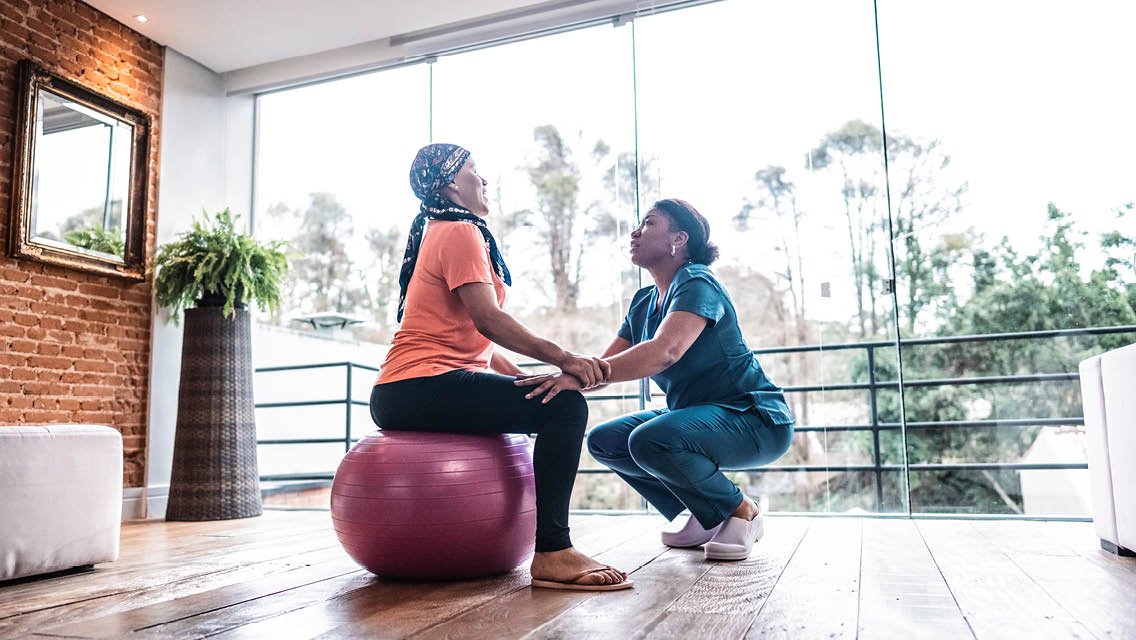 a woman with cancer works with a personal trainer