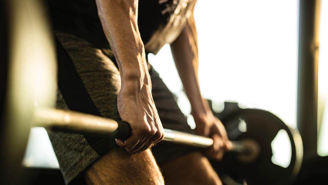 a man lifting a barbell