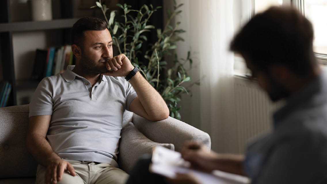 a man look out the window during a therapy session