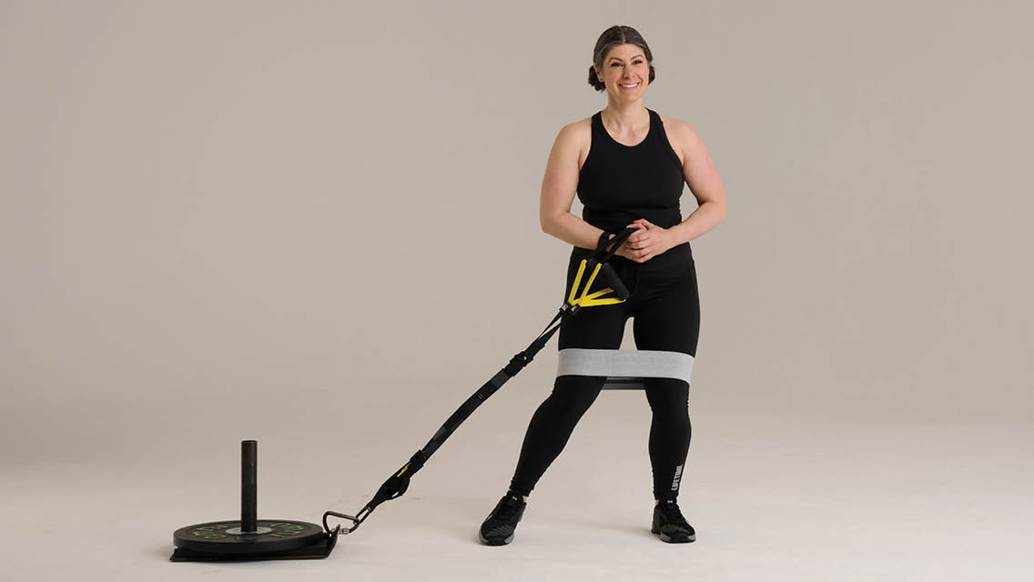 a woman pulls a weighted sled