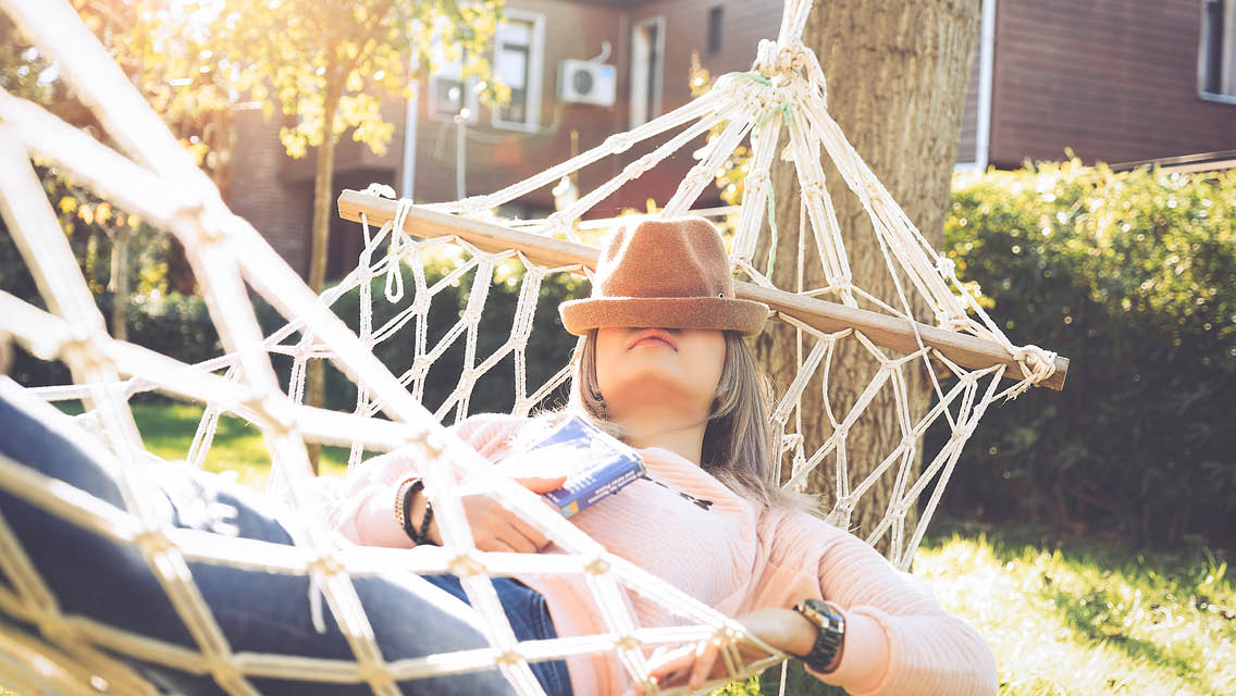 a woman rests in a hammock