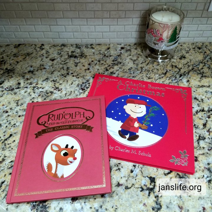 A Charlie Brown Christmas and Rudolph the Red-Nosed Reindeer books on a counter